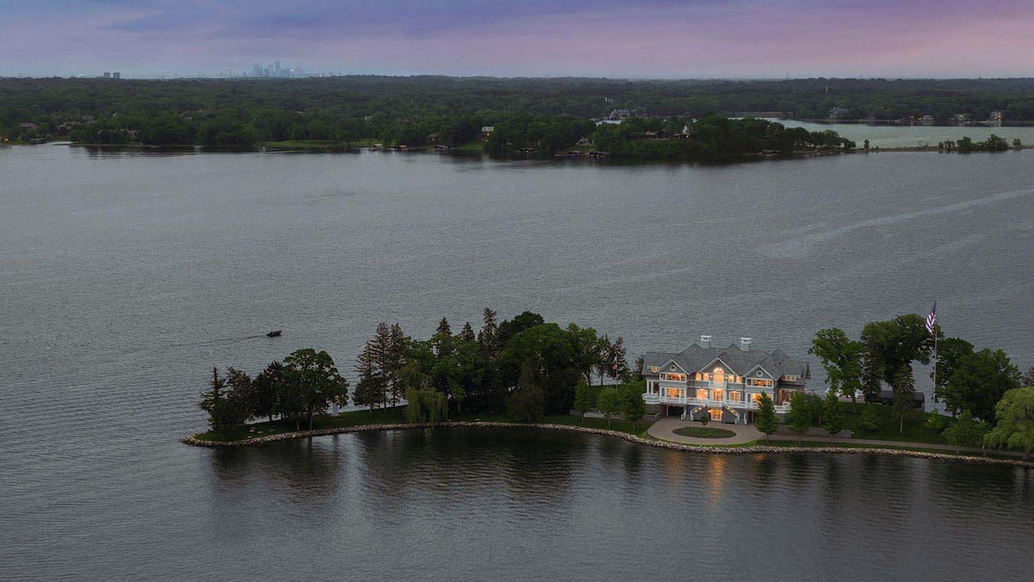 east-coast-shingle-style-lake-house-exterior-aerial-view-at-dusk