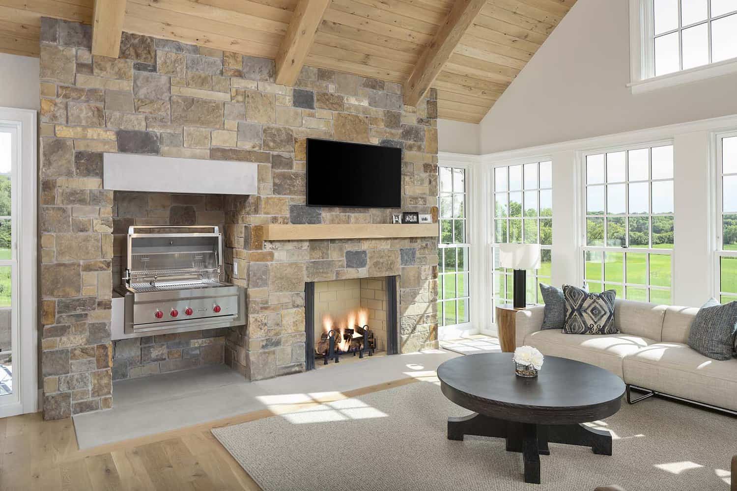 modern-farmhouse-sunroom-with-a-fireplace-and-grill