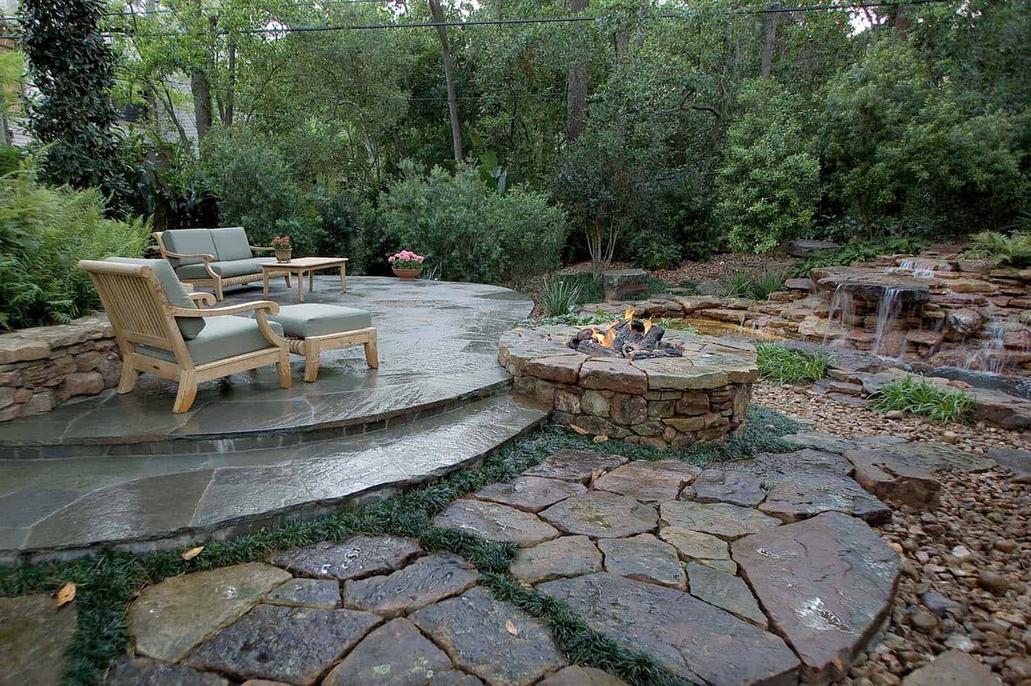 outdoor-fireplace-with-a-river-rock-landscape-and-gardens