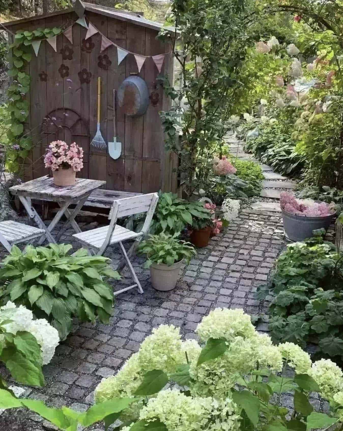 lush garden with a trellis and a shed