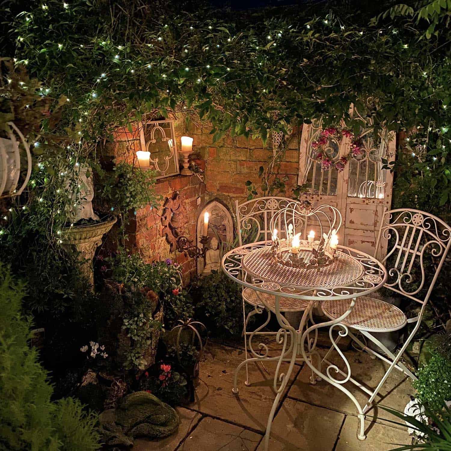 cozy garden nook with a dining bistro set and string lights