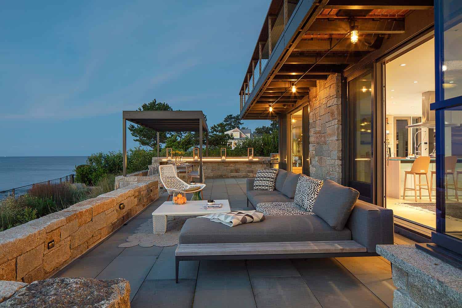 beach house exterior deck with lounge chairs at dusk