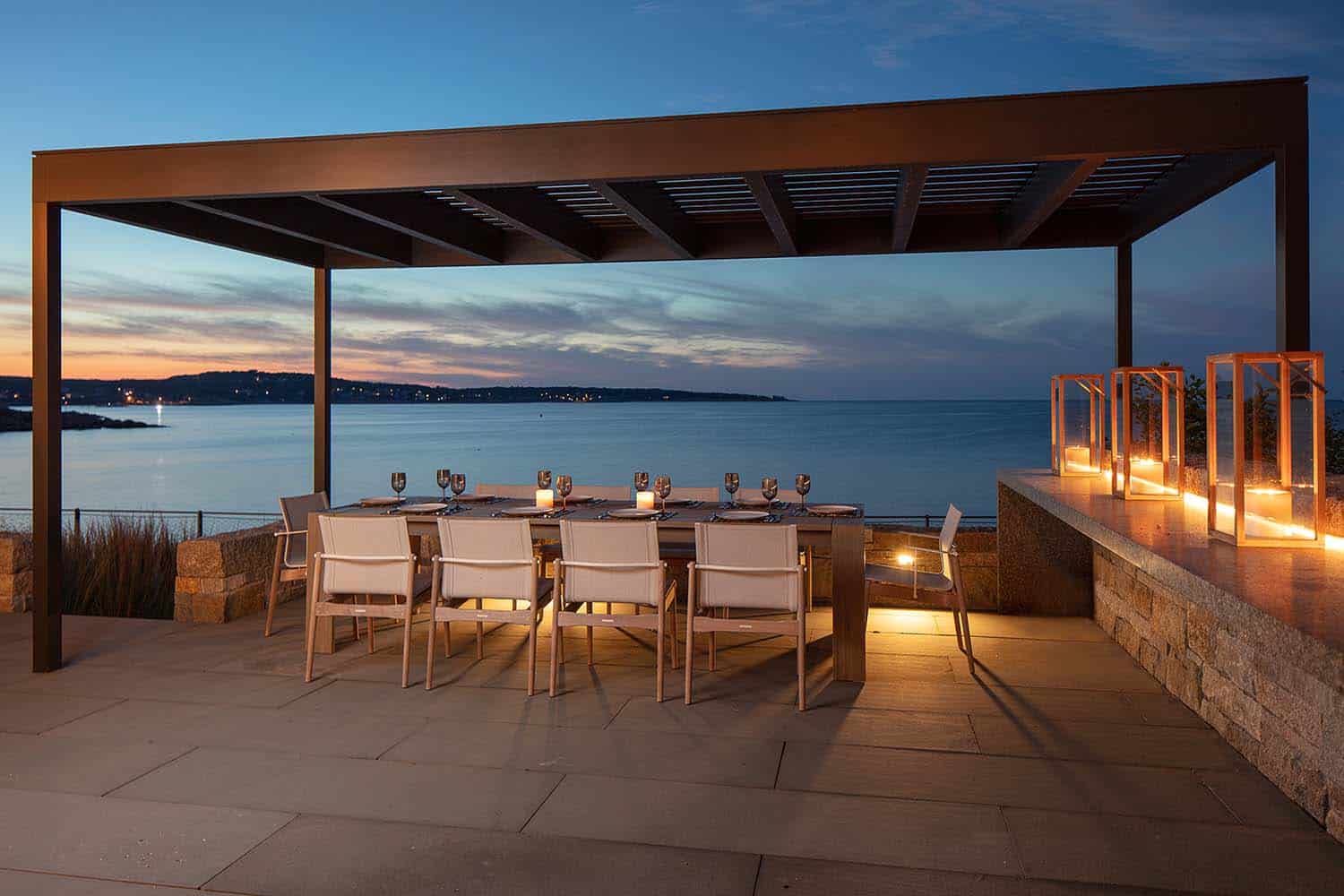 beach house exterior deck with an ocean view at dusk