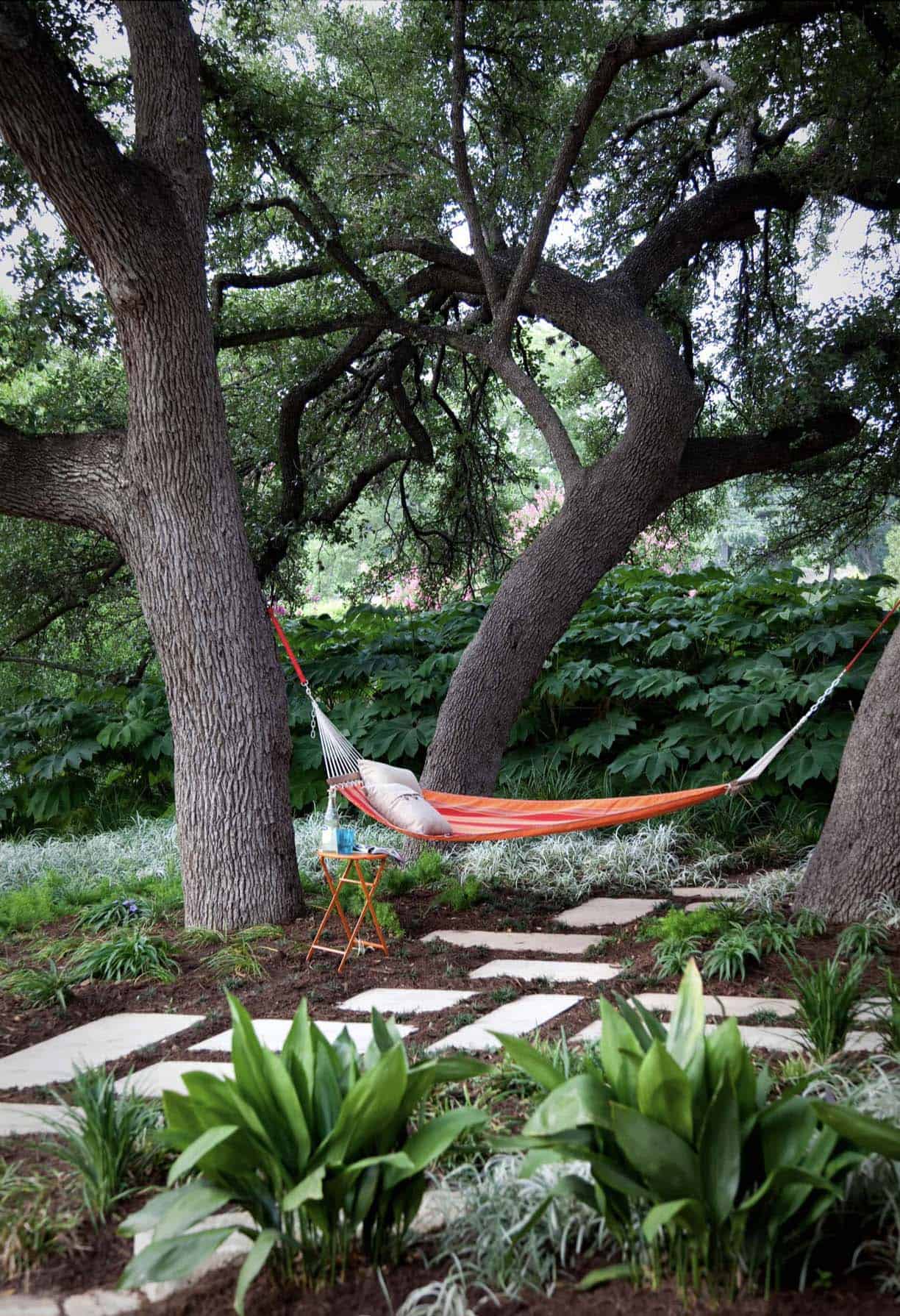 small-backyard-patio-with-a-hammock-hanging-from-the-trees