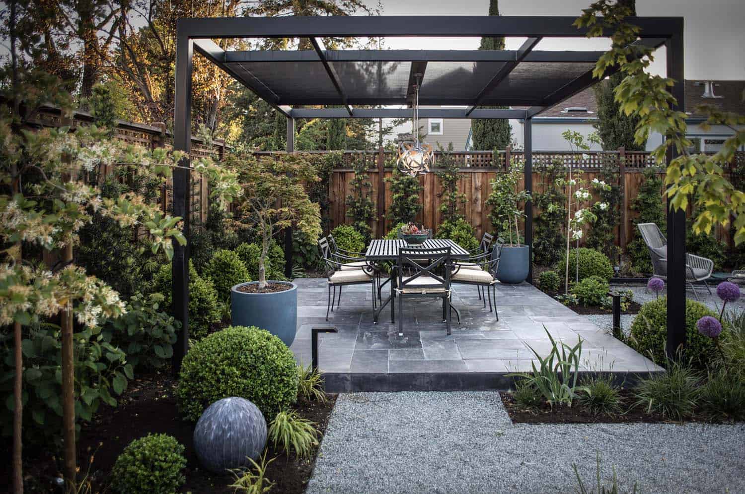 small-backyard-patio-with-a-pergola-and-gardens