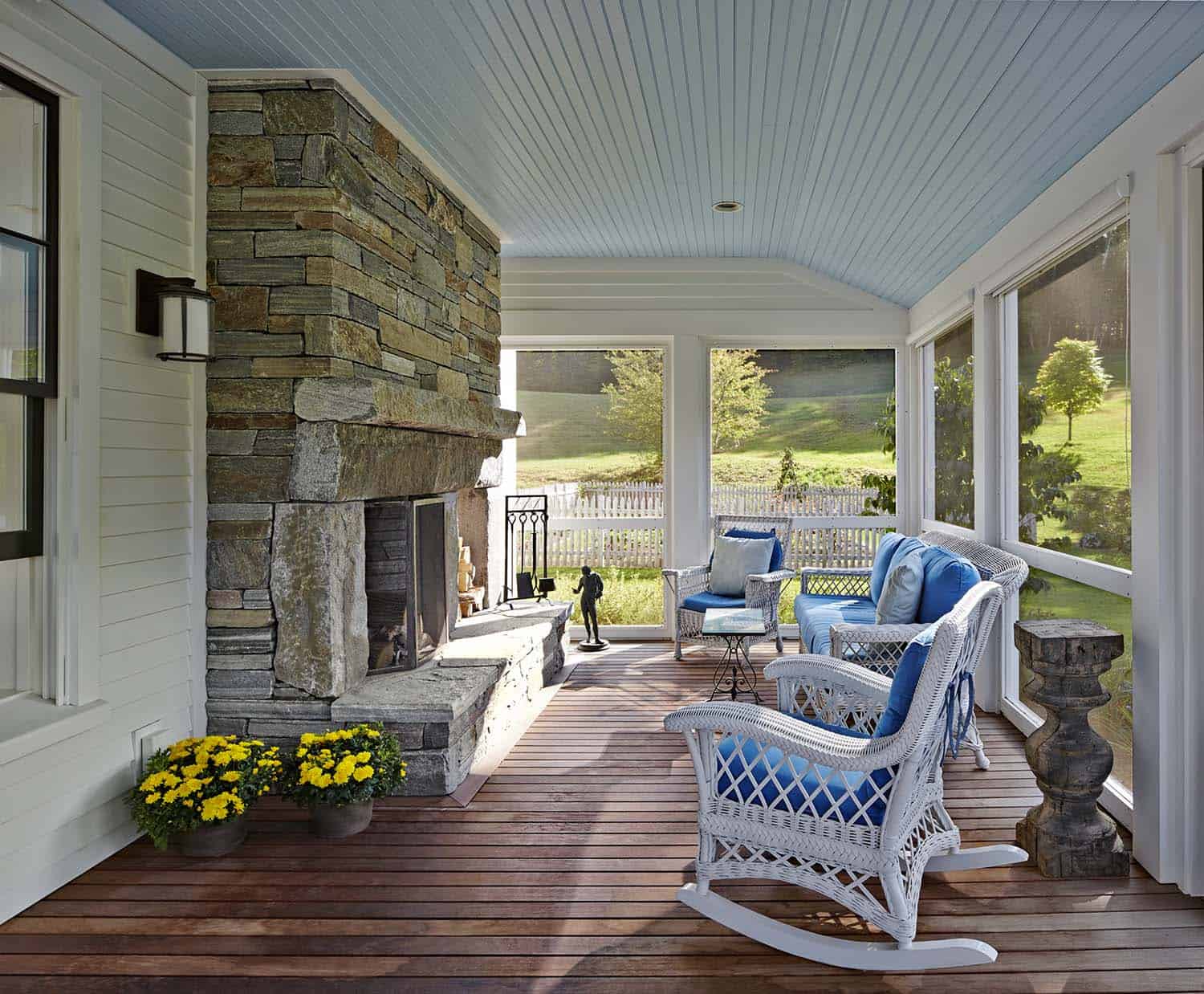 federal style farmhouse screen porch with a large fireplace
