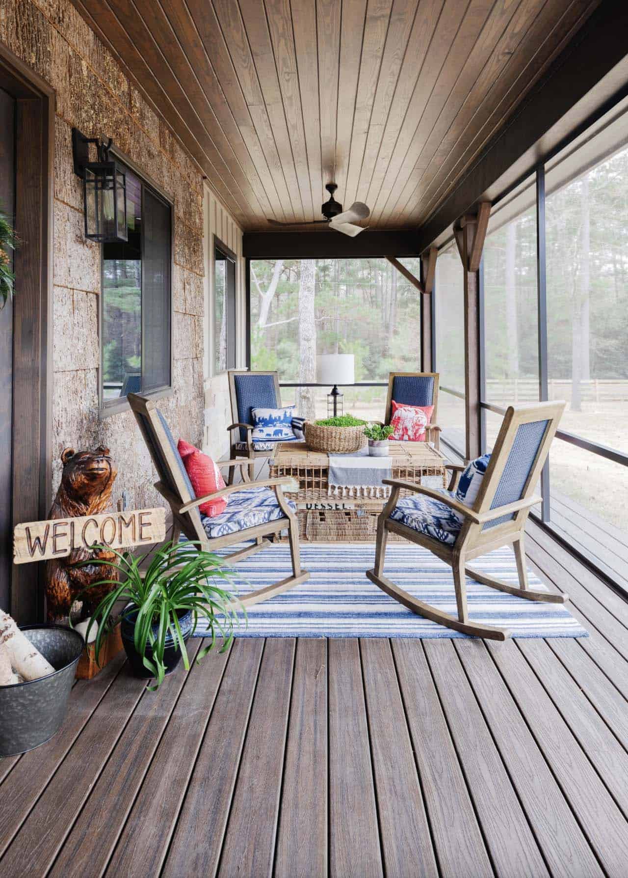 rustic screened porch with rocking chairs and bark siding