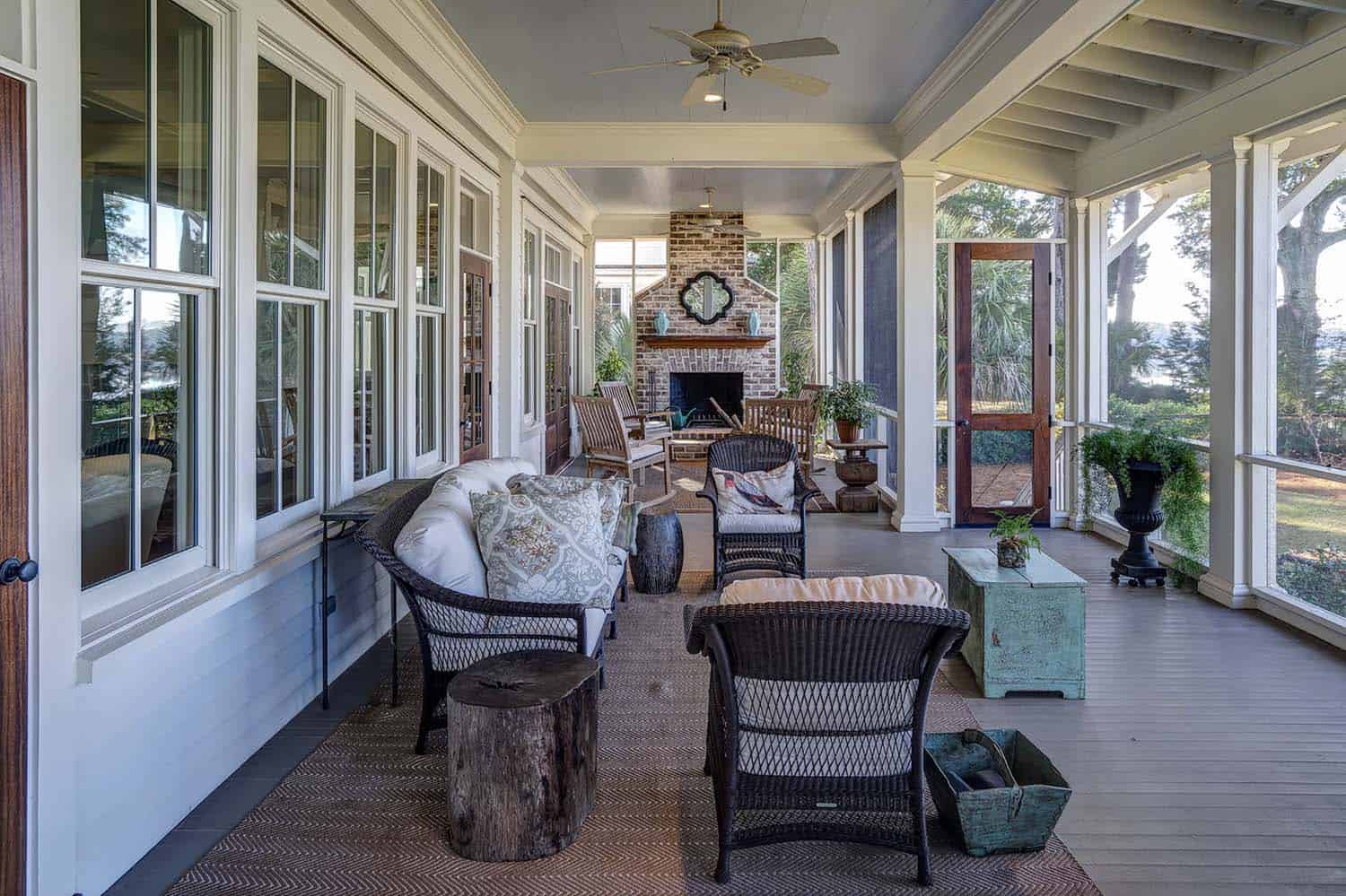 traditional style screen porch with a brick fireplace