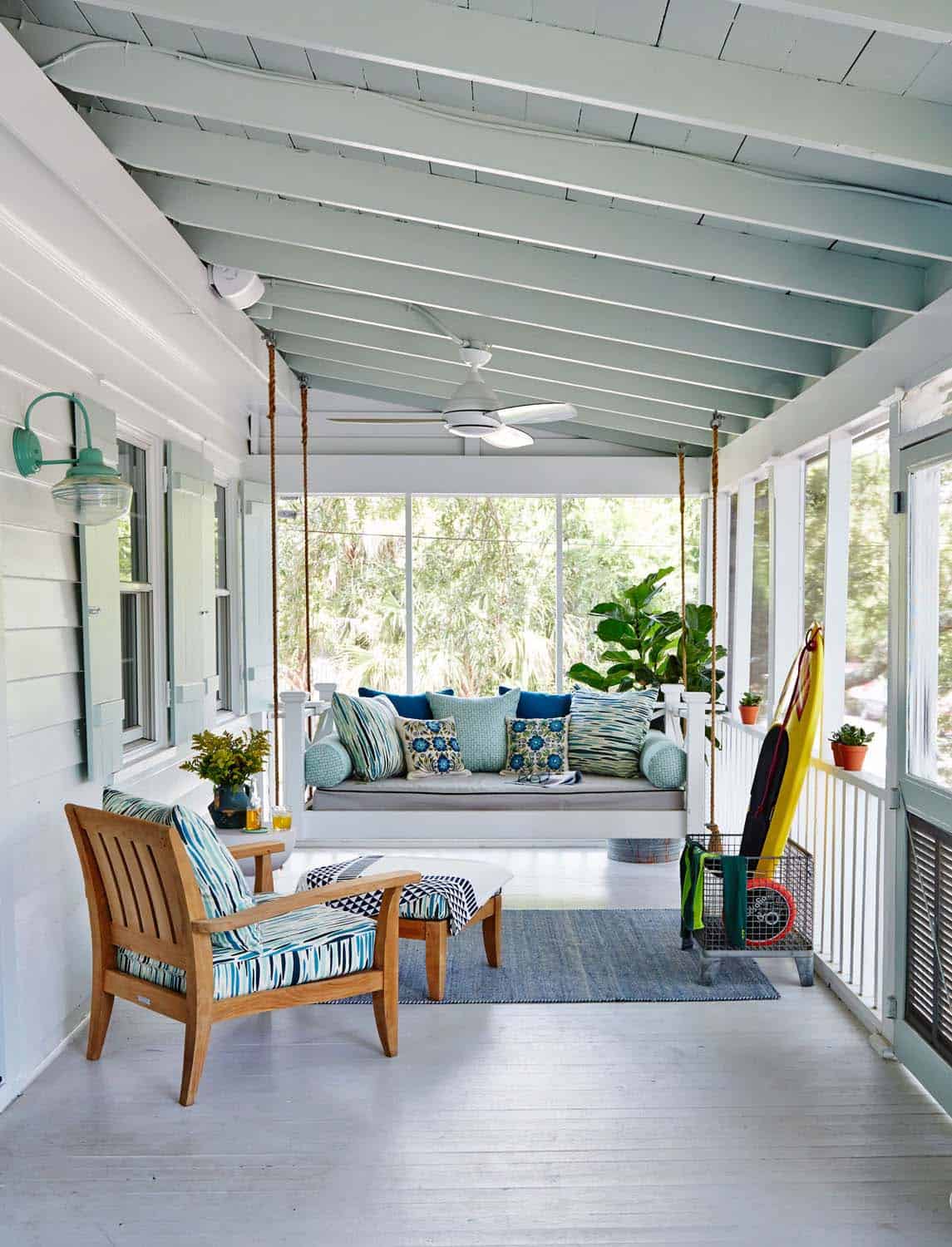coastal cottage screened porch with a hanging daybed