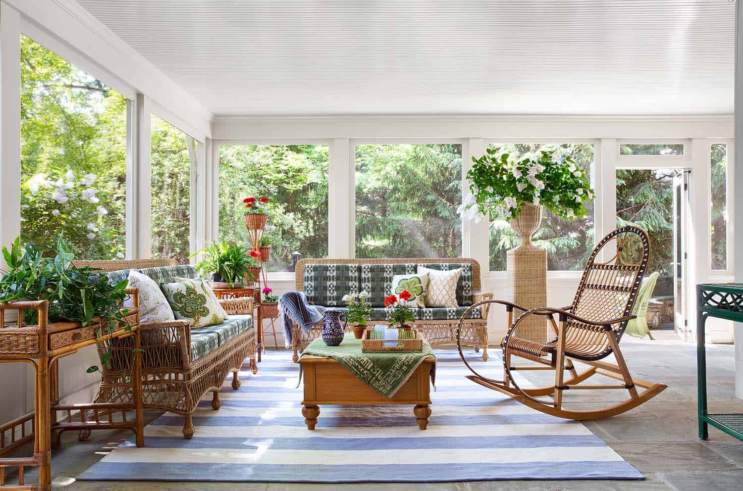 screened porch with wicker furniture and plants