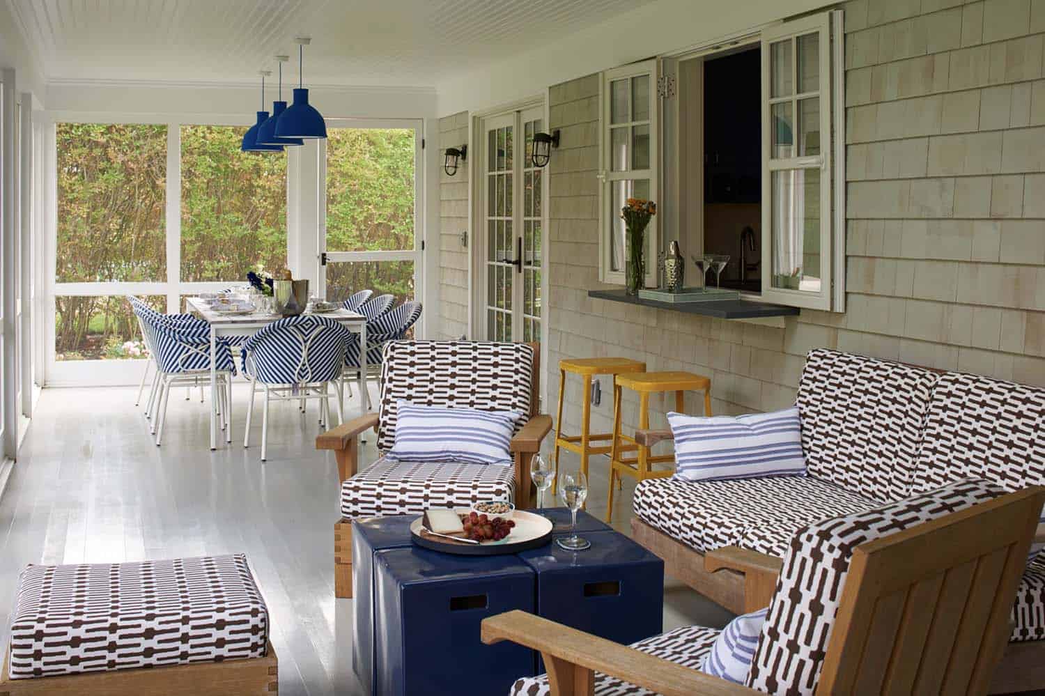 coastal style screened porch with a pass through window from the kitchen