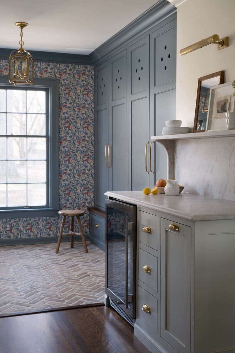 transitional mudroom with patterned wallpaper and herringbone brick flooring