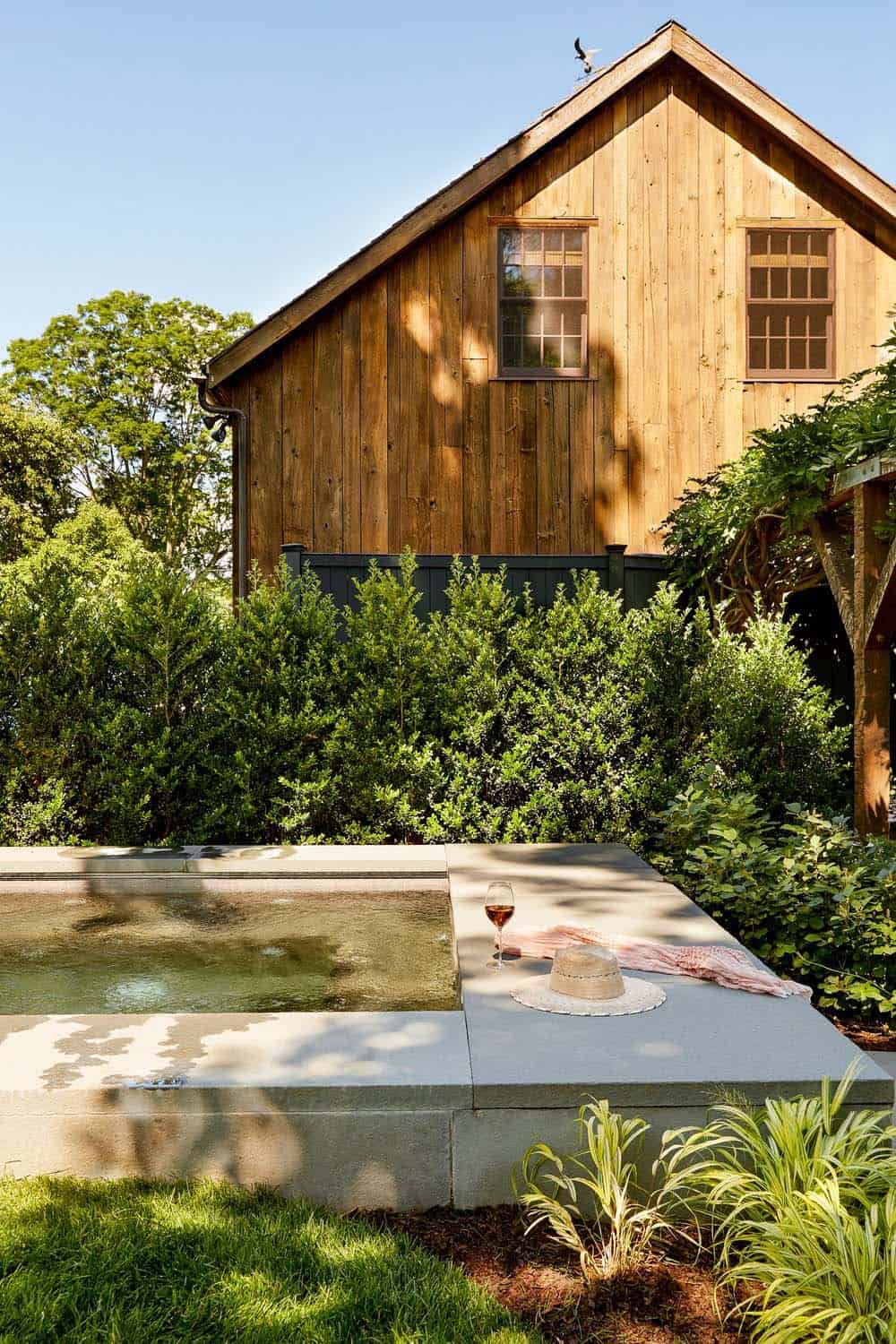 rustic party barn with an outdoor hot tub and surrounding landscape
