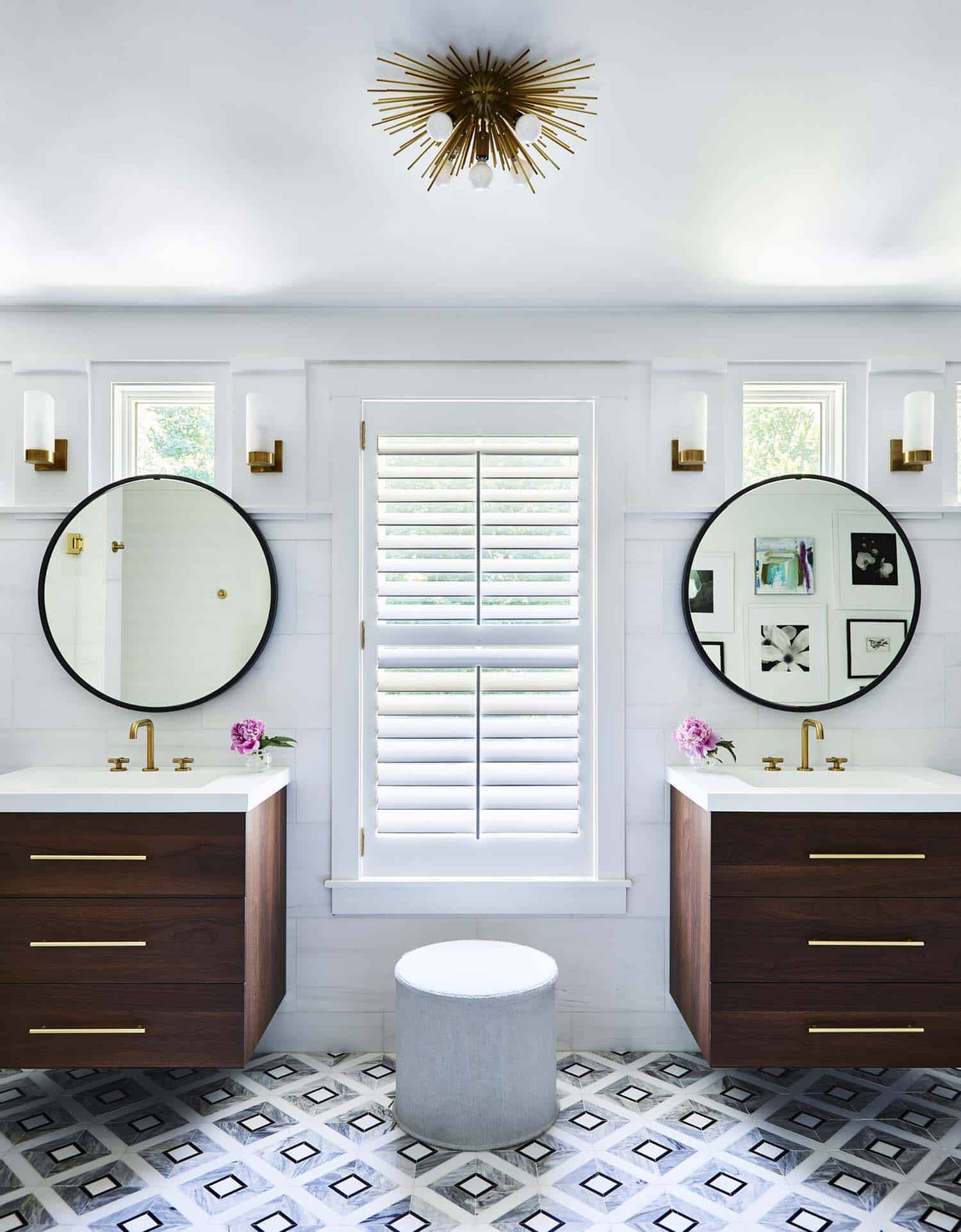 contemporary bathroom with dual vanities and round mirrors