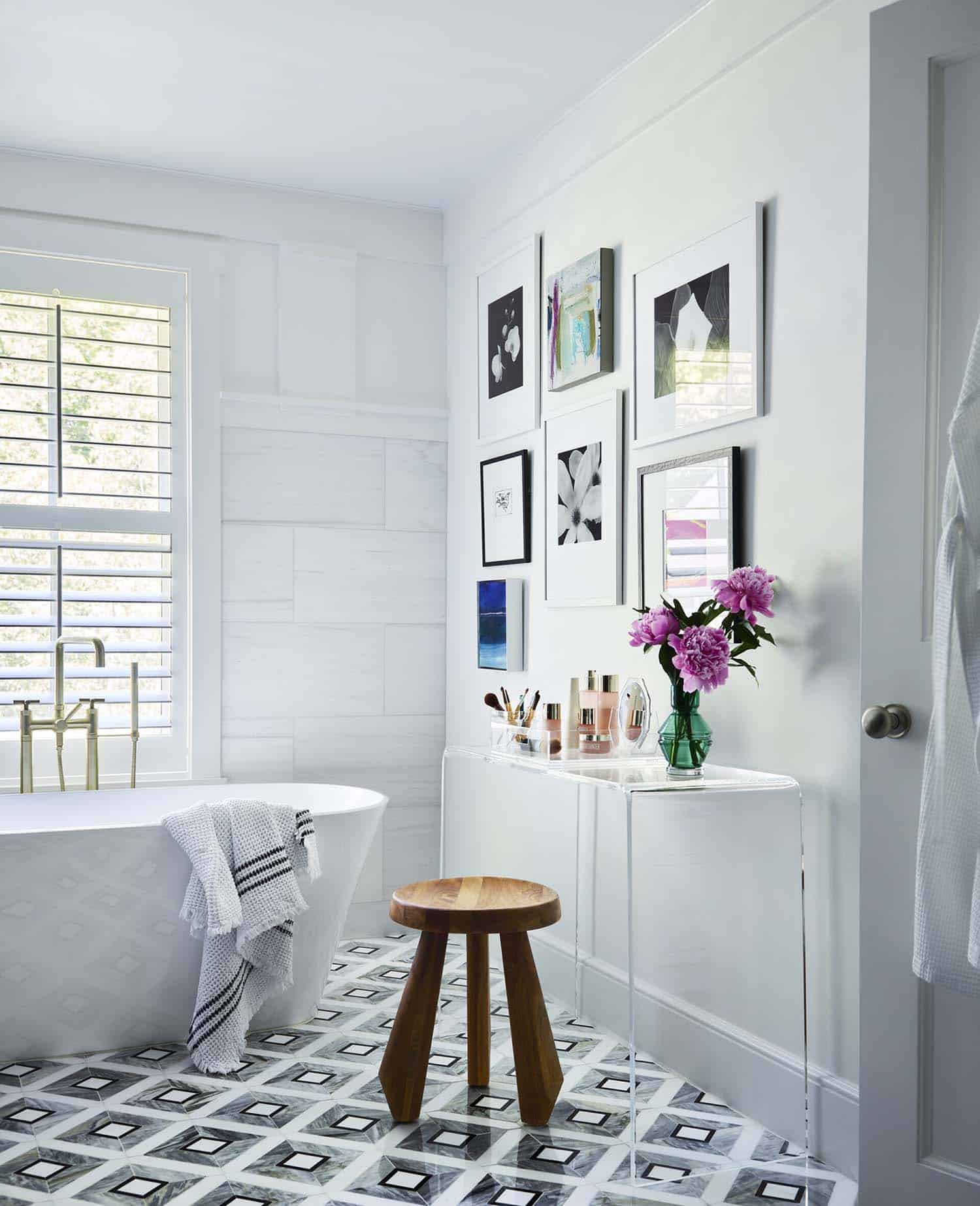 contemporary bathroom with a freestanding tub and a stool