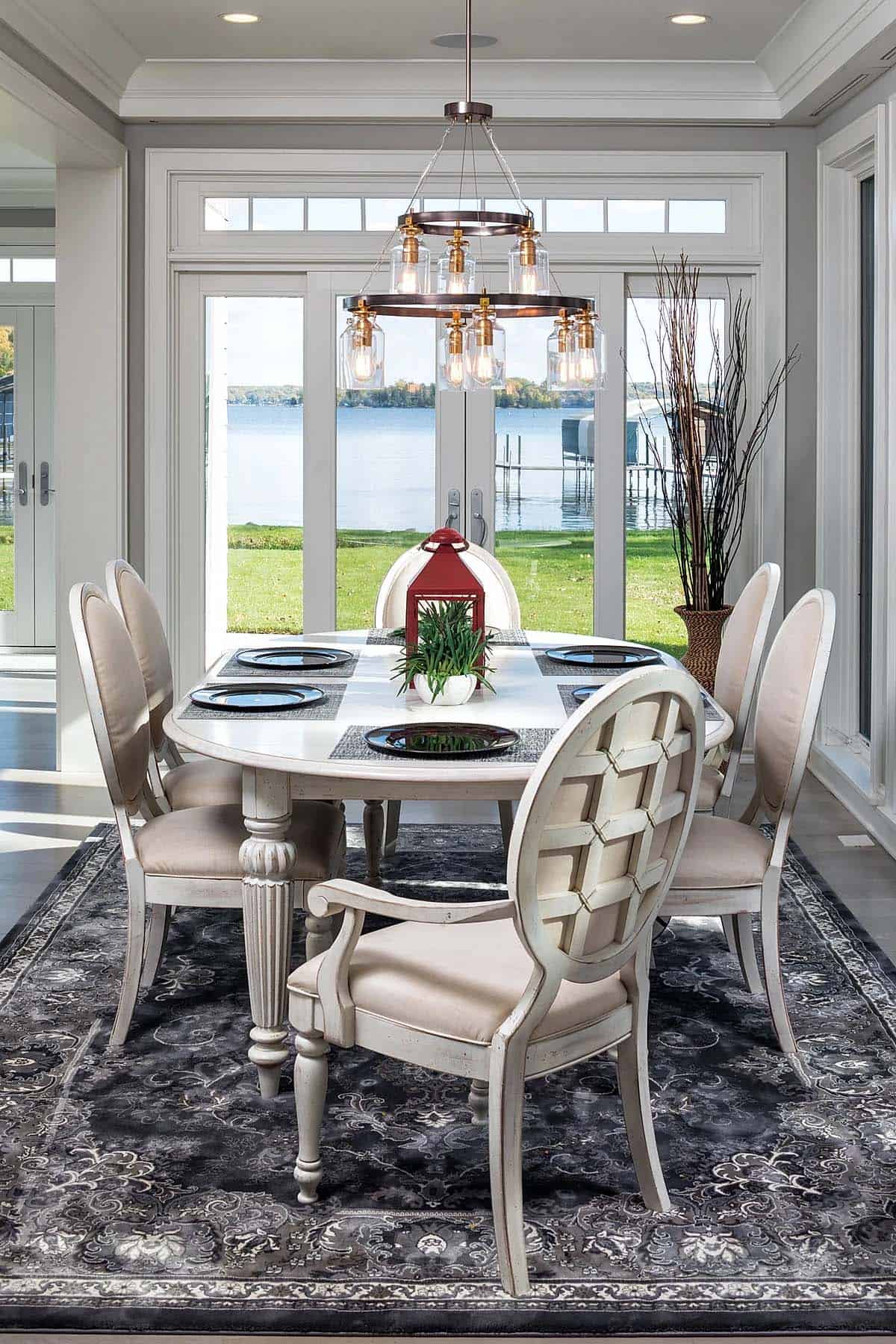 contemporary dining room with a large window and water view