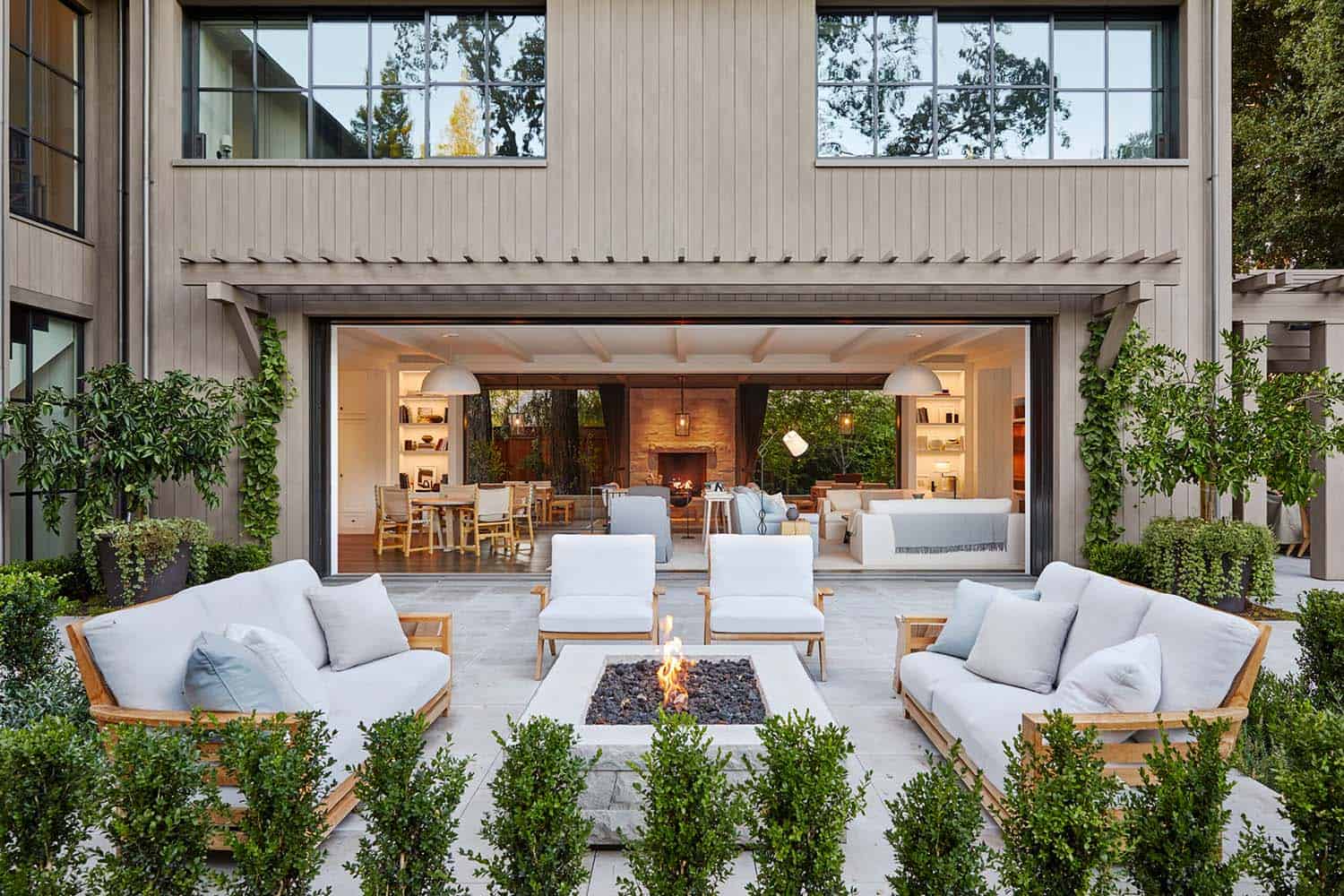cool contemporary home exterior patio with a fire pit and lounge chairs