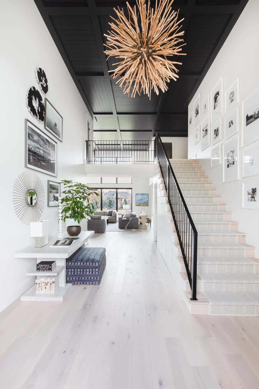 transitional style home entry with a staircase and high ceiling