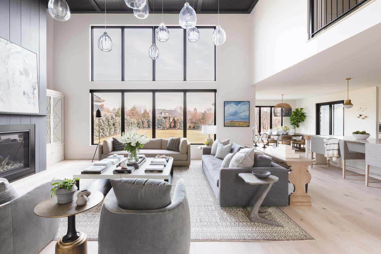 transitional style living room with high ceilings and a large window