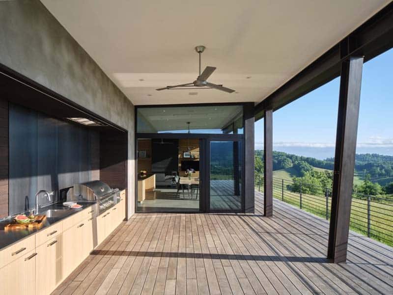 modern meadow house exterior covered porch with outdoor kitchen
