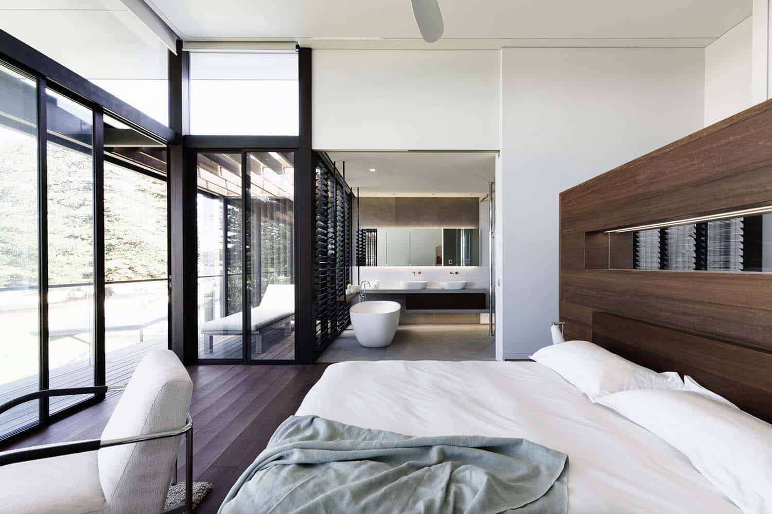 modern beach house bedroom with a wall of sliding glass doors