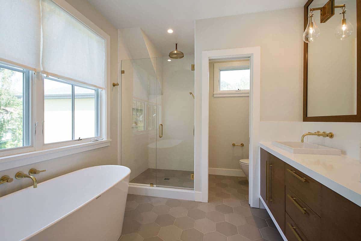 modern farmhouse bathroom with a vanity and freestanding tub and glass shower