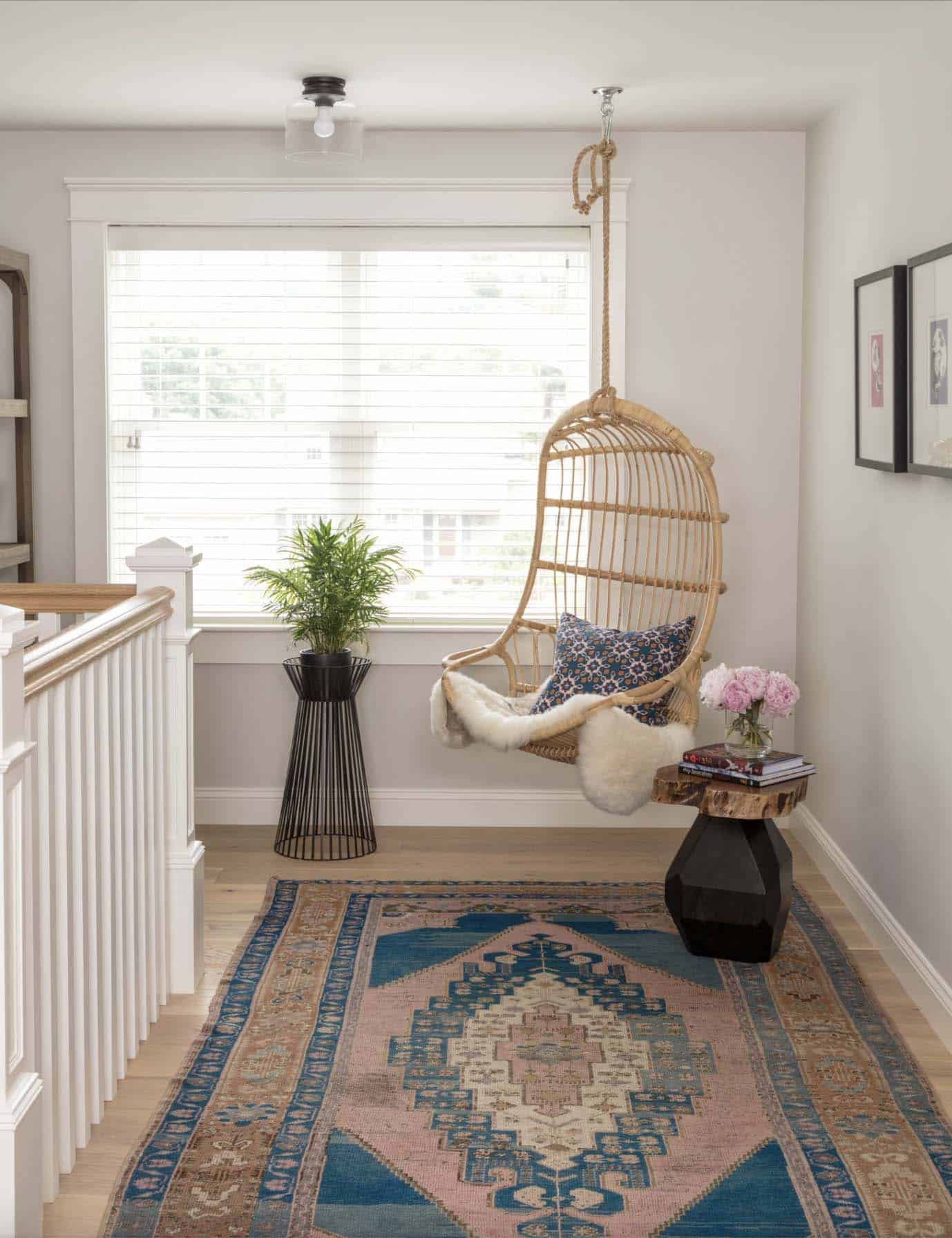 farmhouse upstairs hallway with a hanging chair and vintage runner