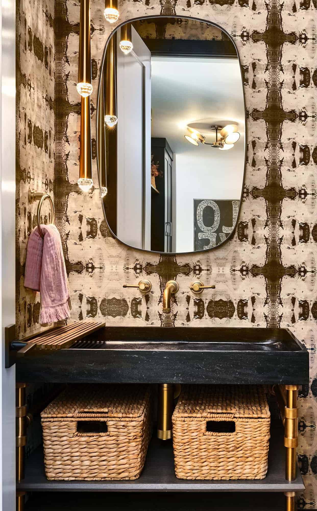 modern powder bathroom with graphic wallpaper and a mirror