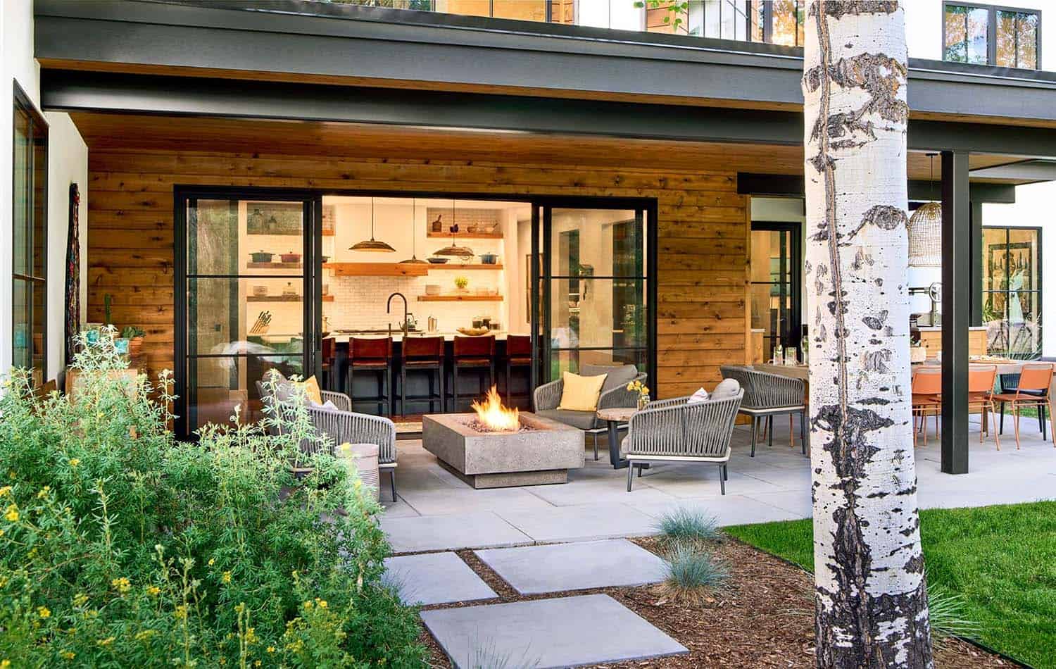 modern mountain home patio with a fire pit