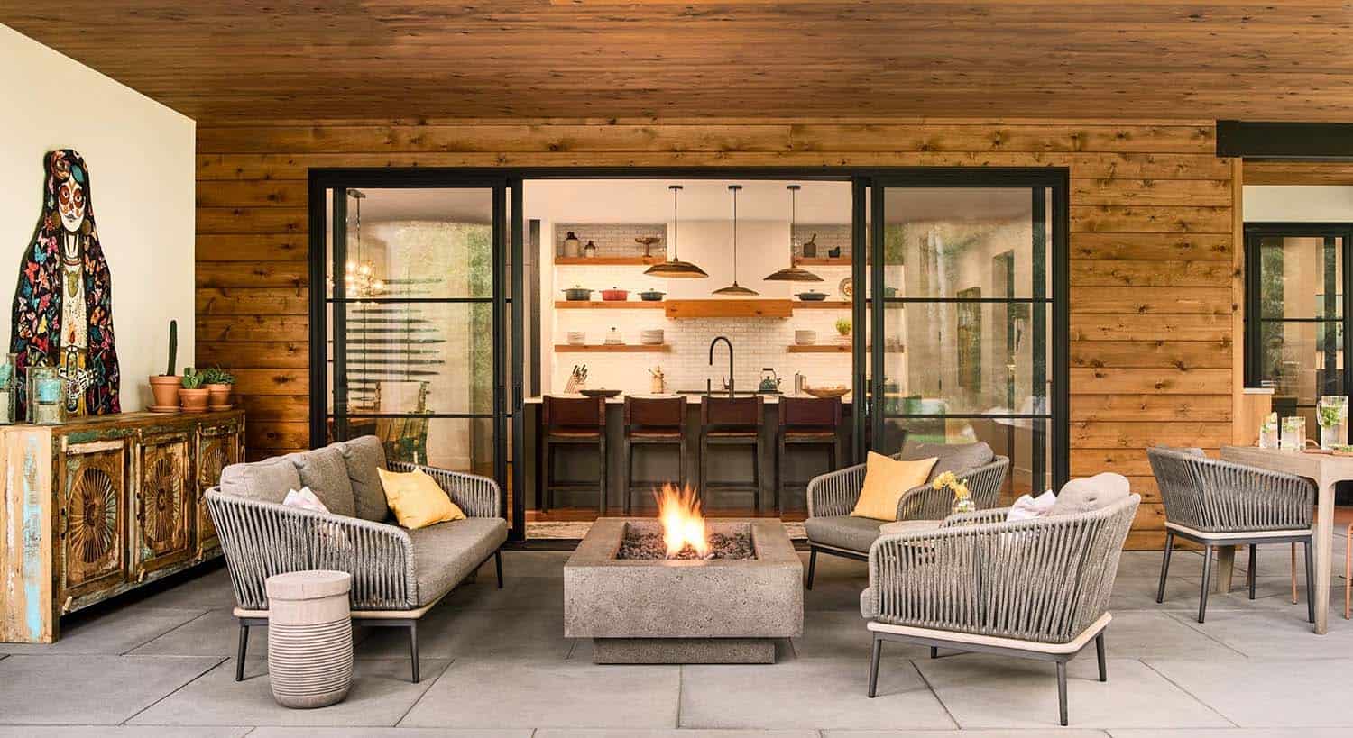 modern mountain home patio with a fire pit