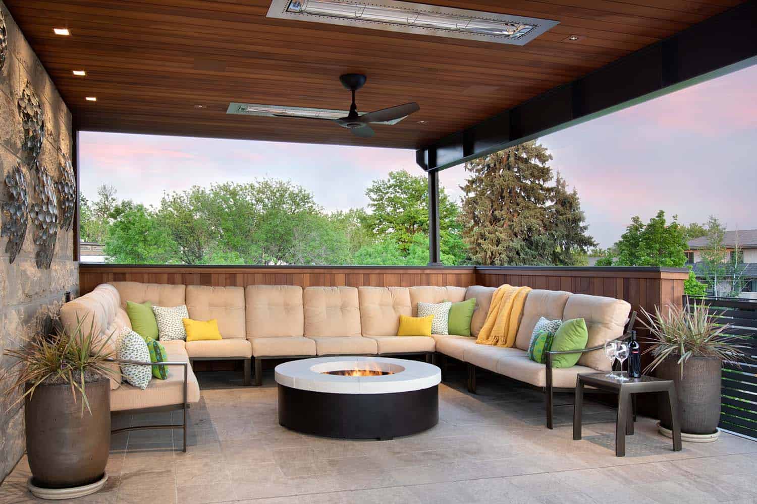 modern rooftop deck with a sectional sofa and a fire pit