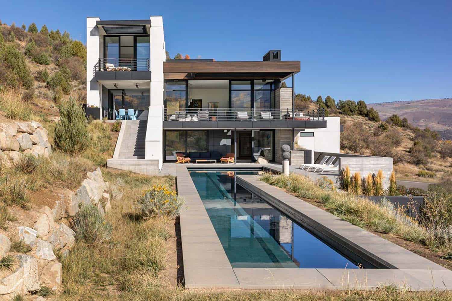 mountain modern home exterior with a lap pool