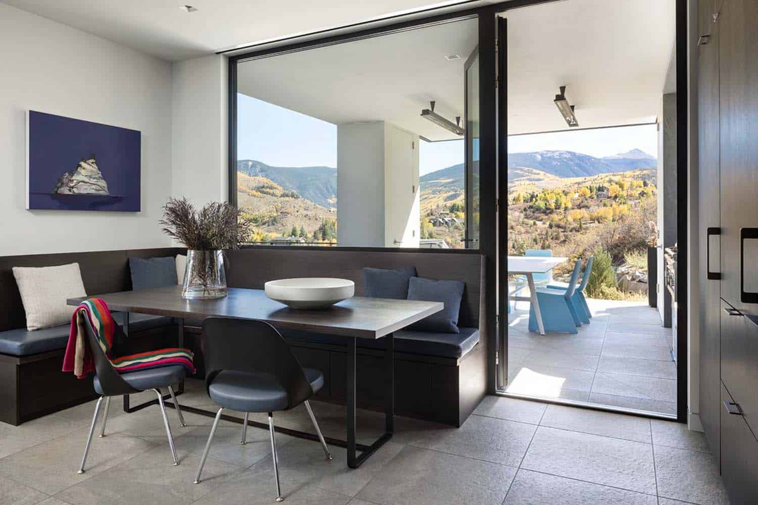mountain modern breakfast nook with a door to the backyard patio