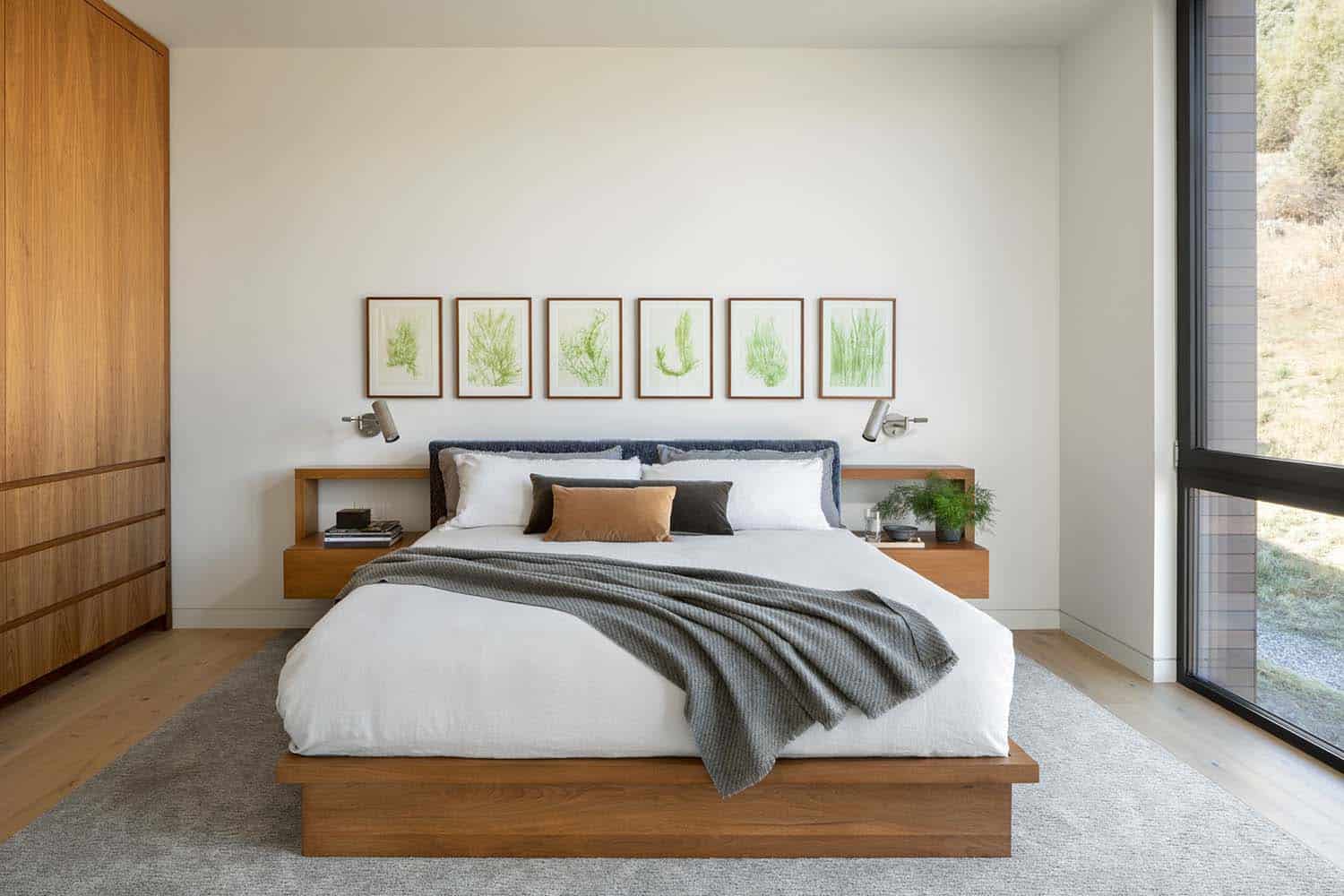 modern bedroom with a platform bed and artwork above the headboard