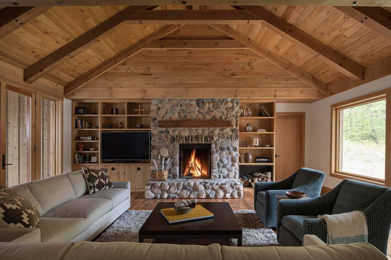 rustic farmhouse style living room with a stone clad fireplace
