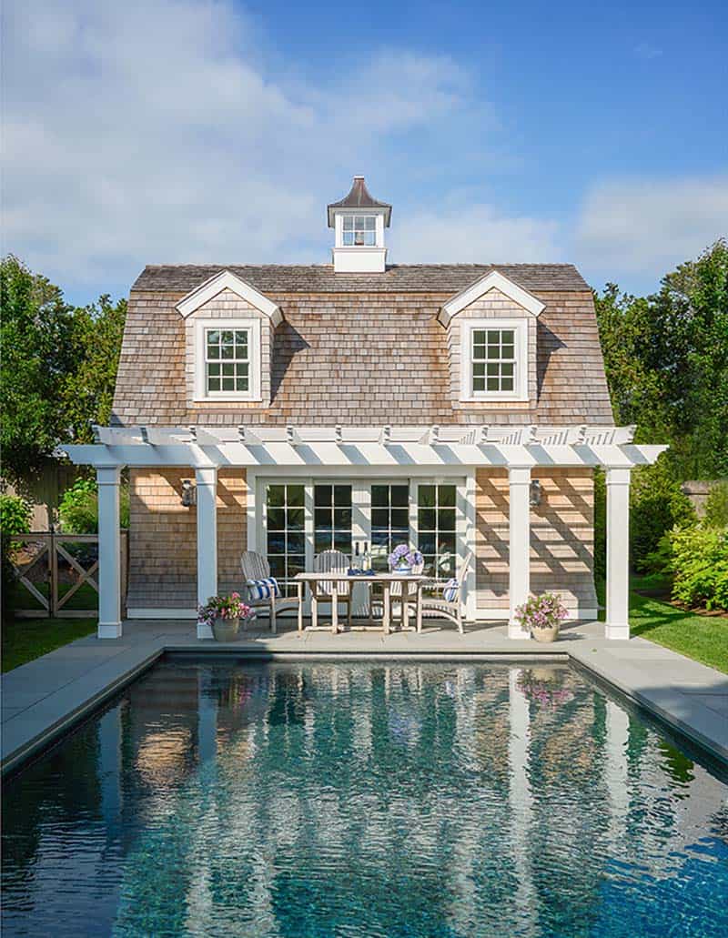 shingle style home exterior with a pool and pool house