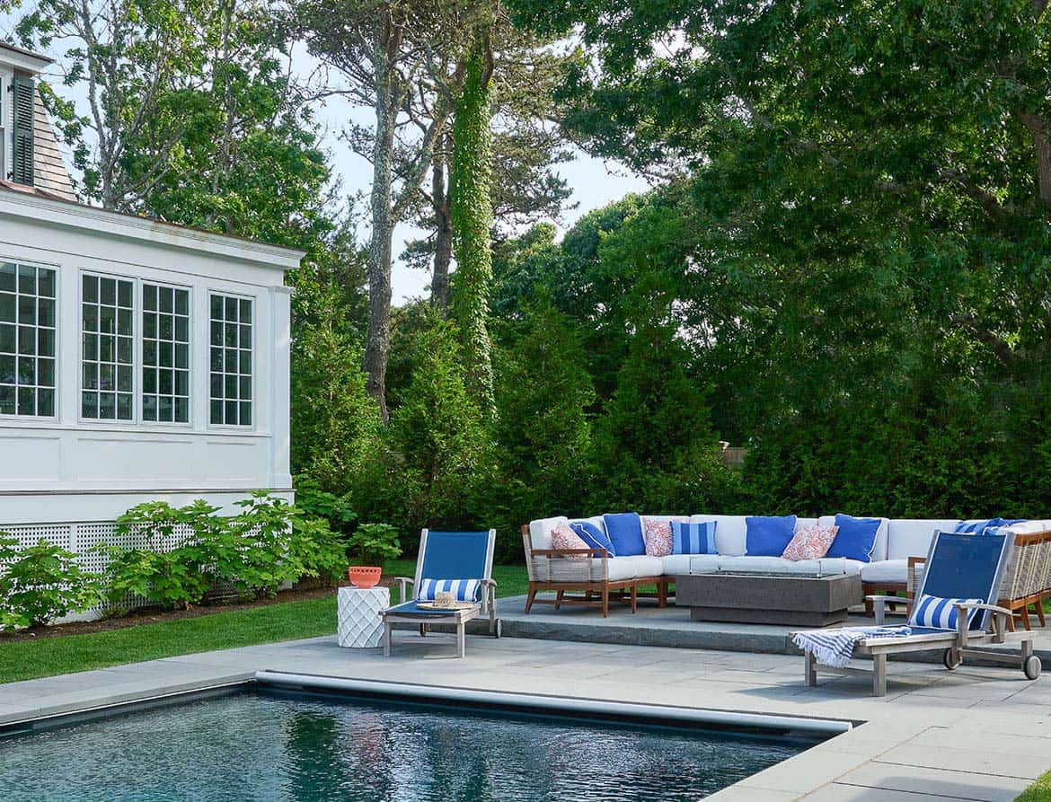shingle style home exterior with a pool