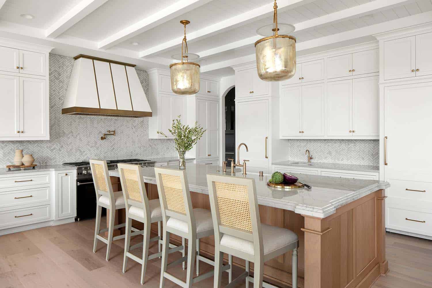 timeless kitchen with white and stained wood cabinets and bell pendant lights