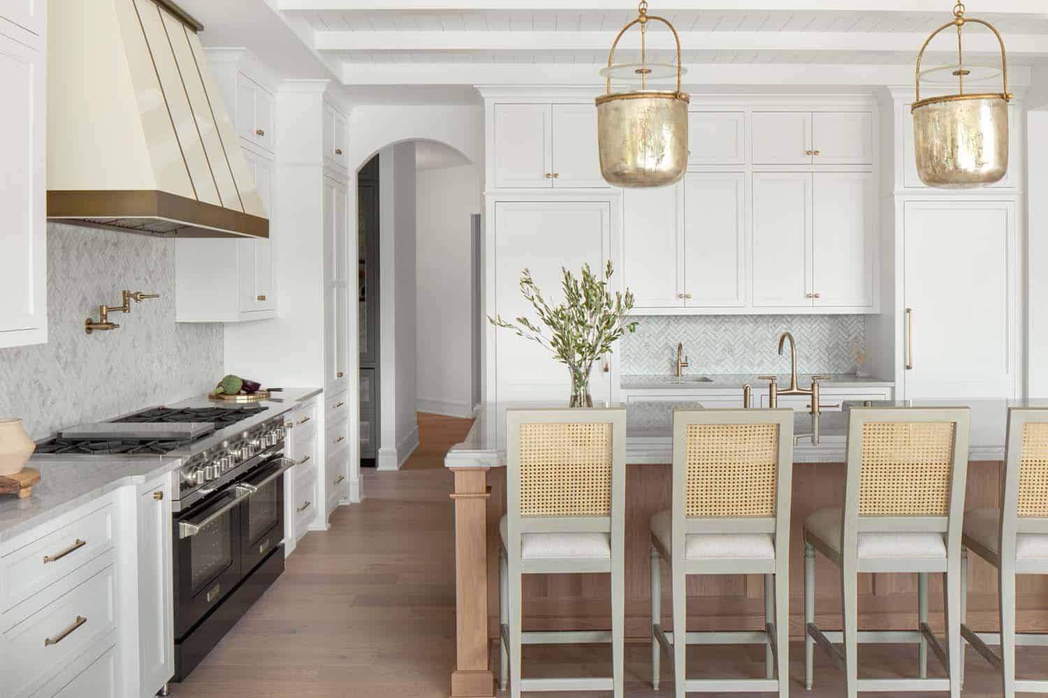 timeless kitchen with white and stained wood cabinets and bell pendant lights