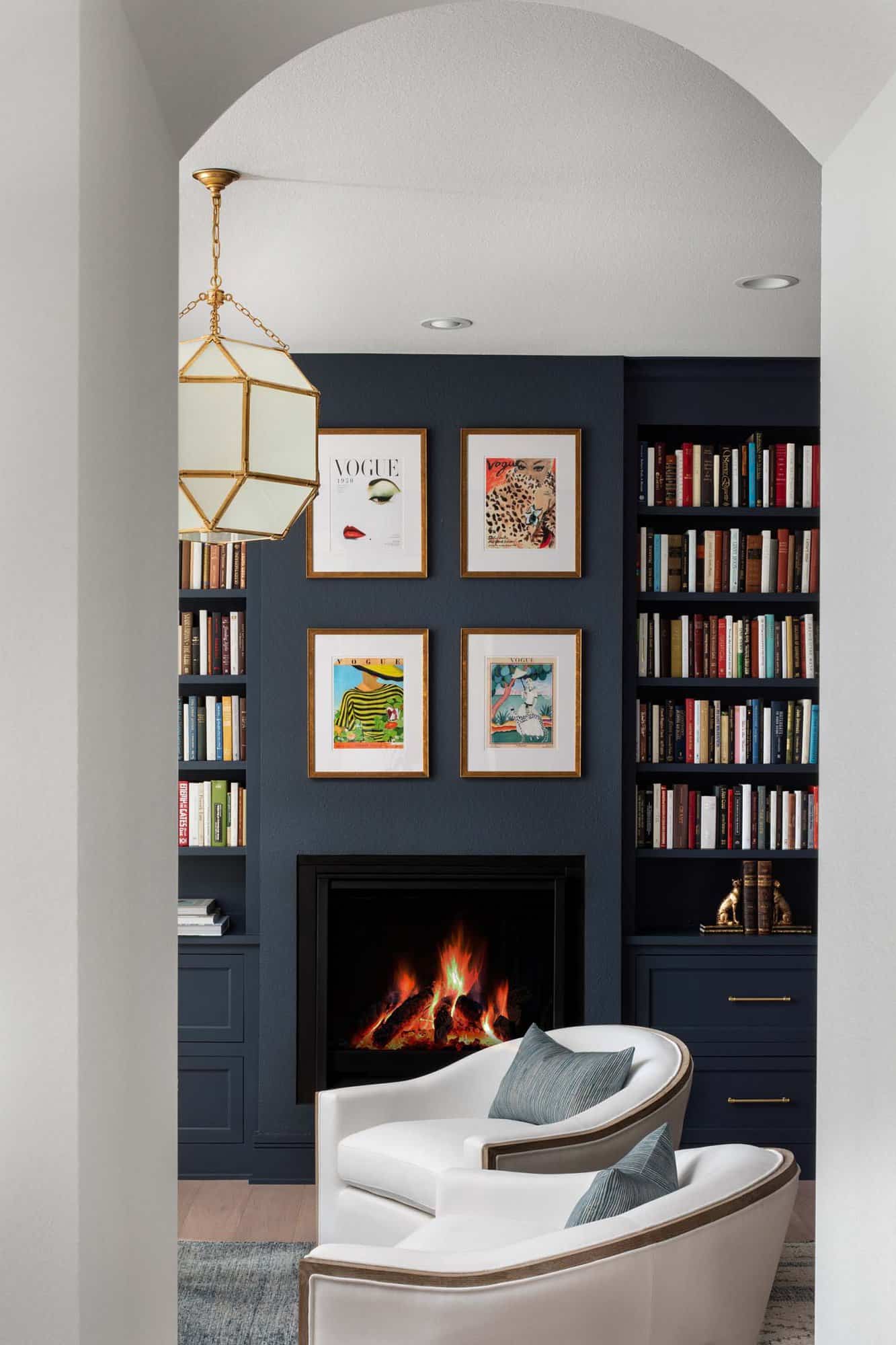 contemporary home office with a fireplace and navy blue walls