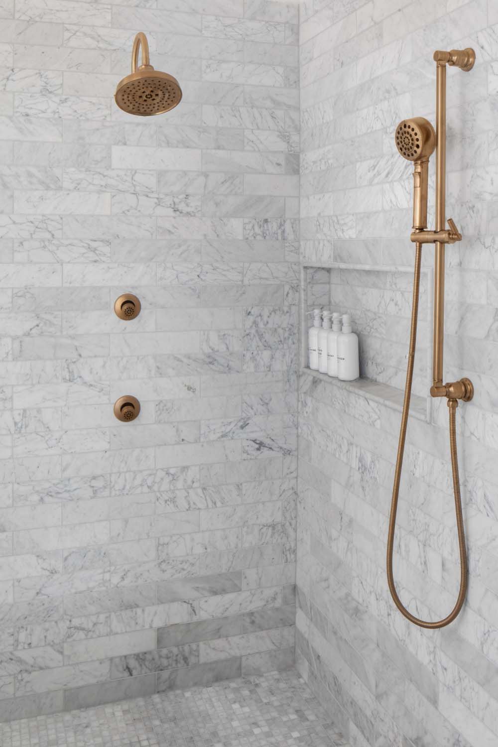 transitional style bathroom shower with white tiles