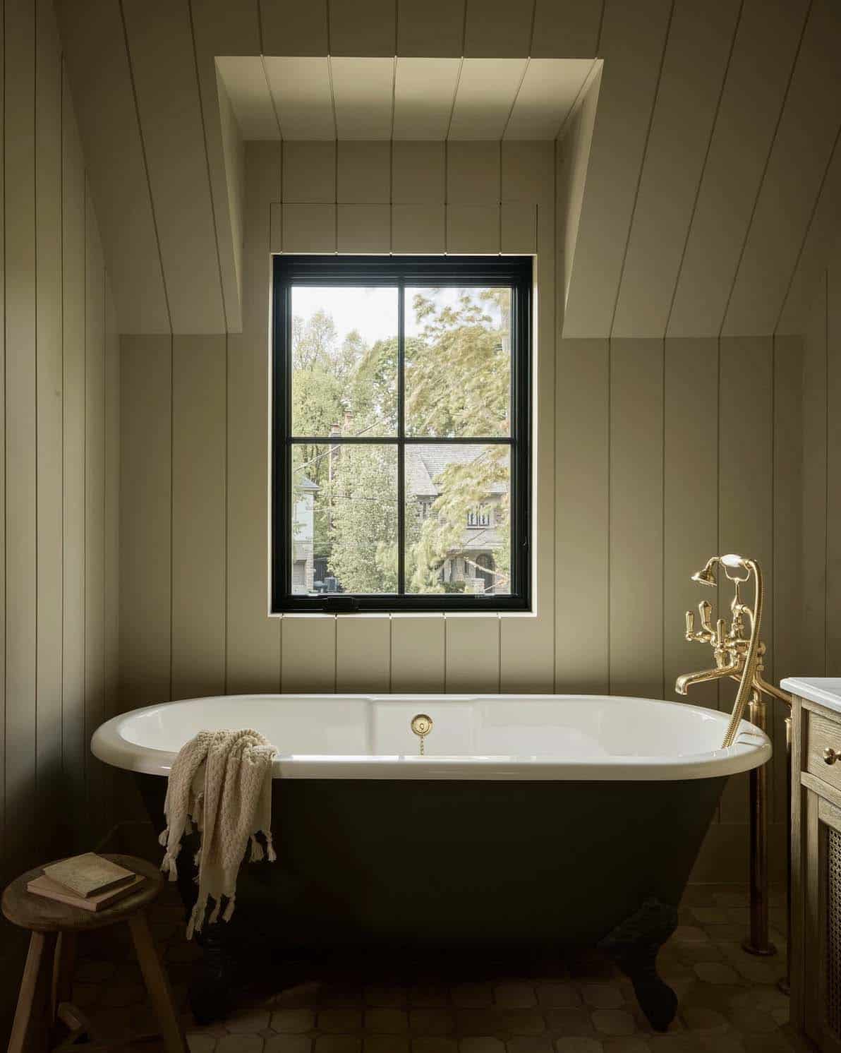 transitional style bathroom with a freestanding tub and a window