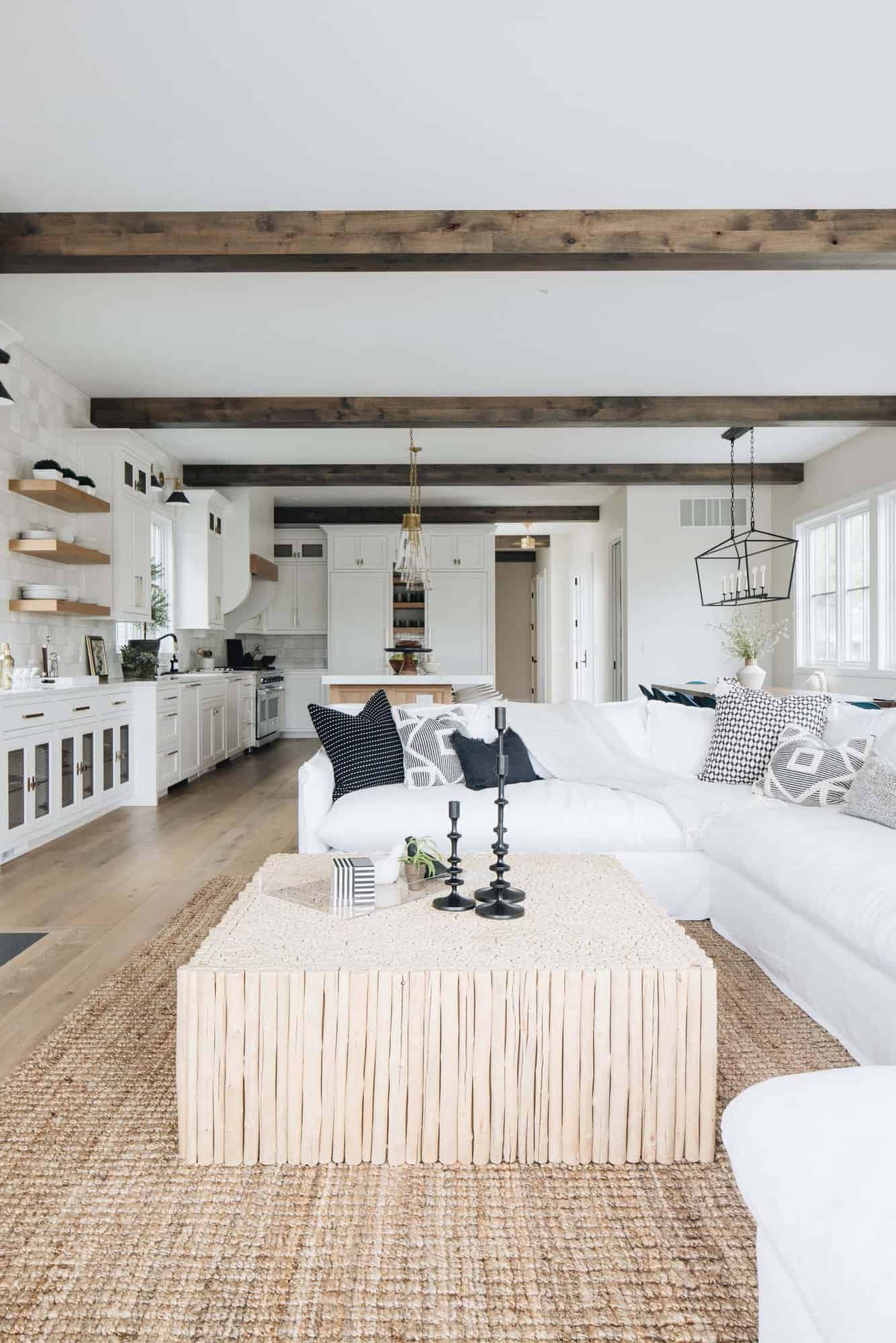 beach style living room with wood beams on the ceiling
