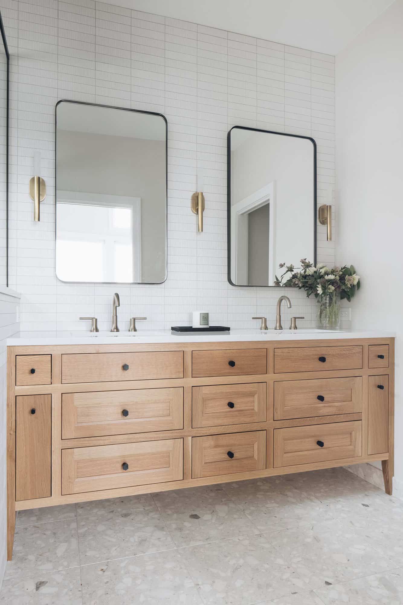 beach style bathroom with a large vanity and two sinks