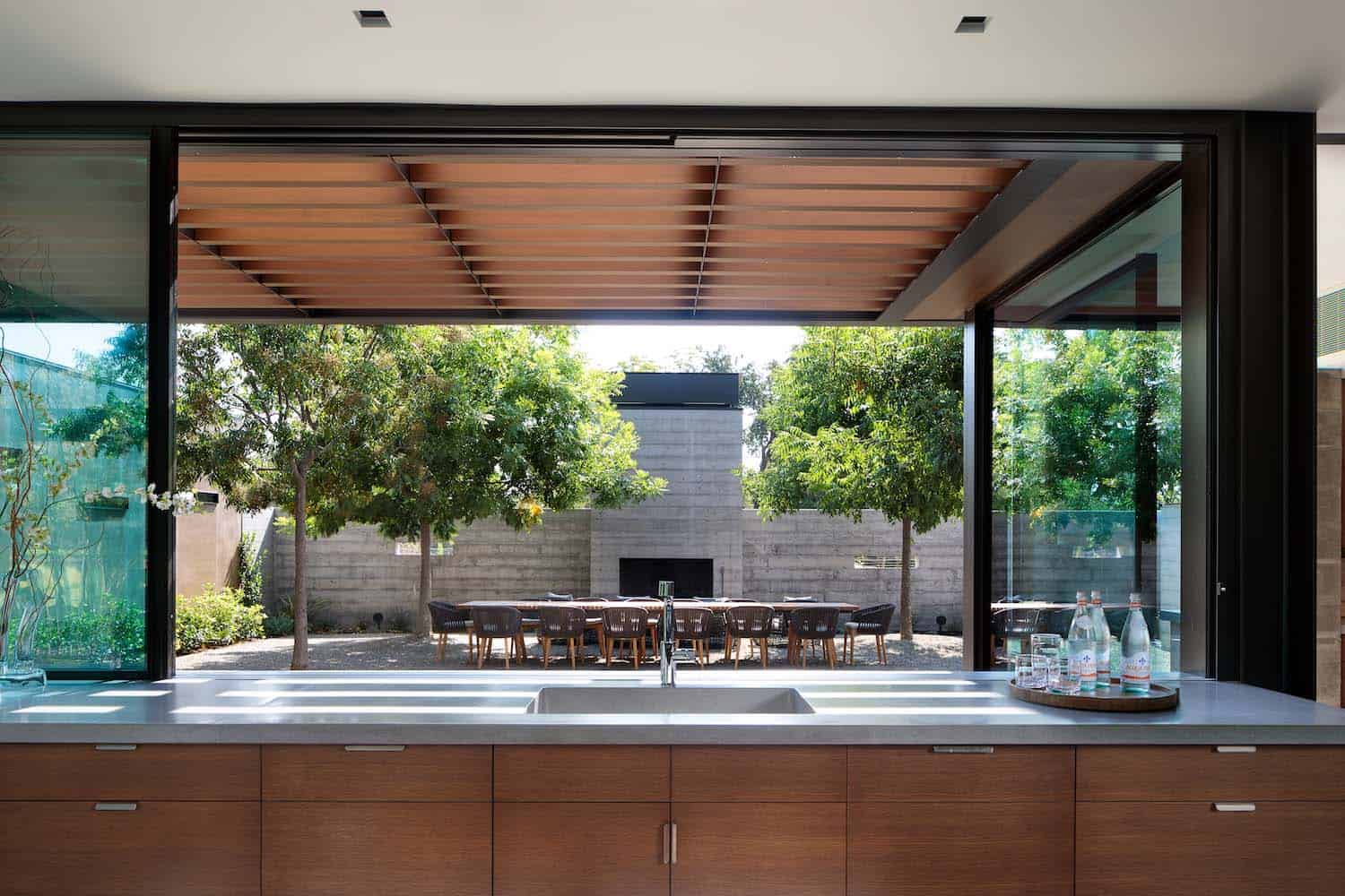 contemporary kitchen sink with a view of the backyard