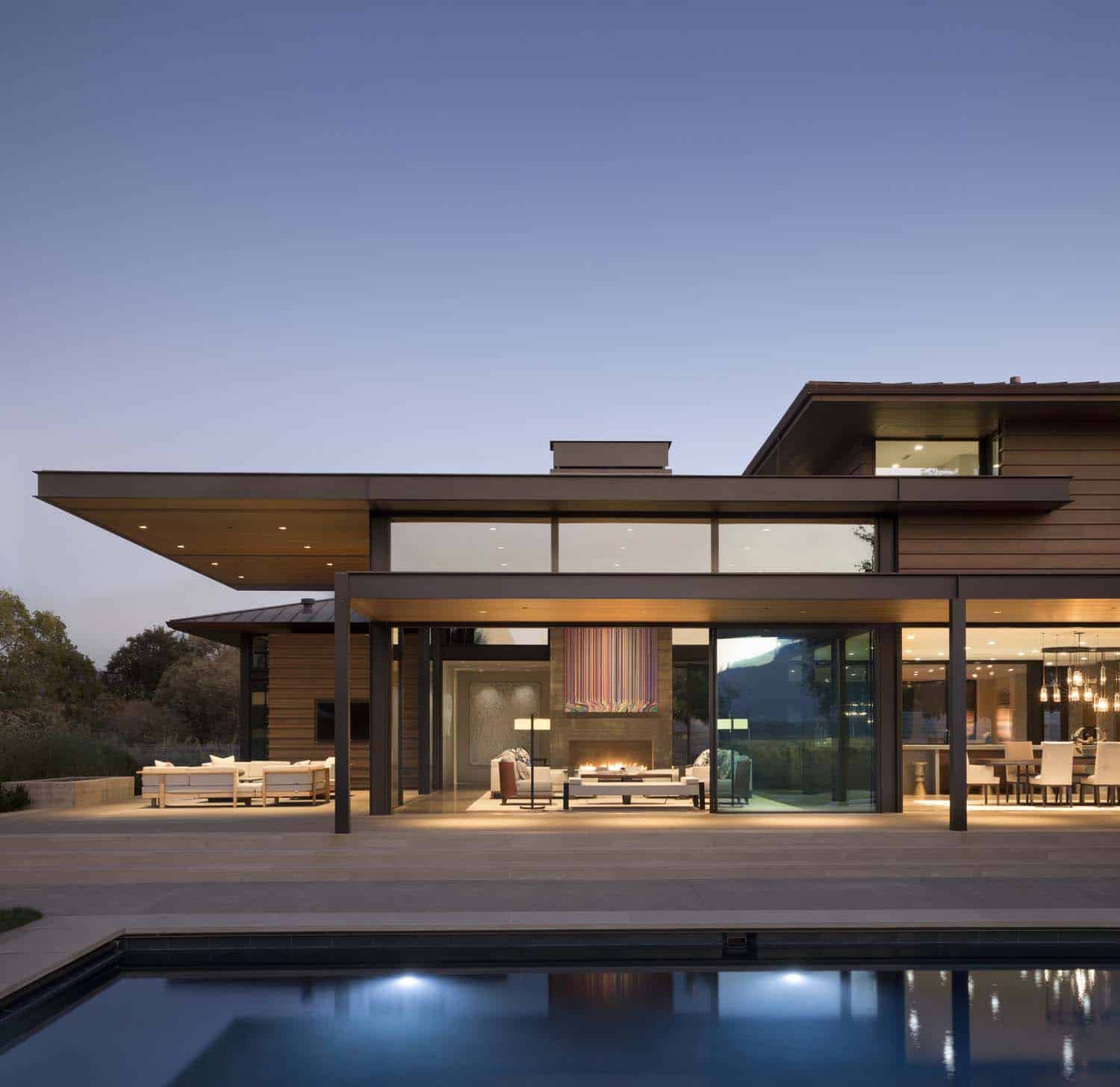 contemporary home exterior and swimming pool at dusk