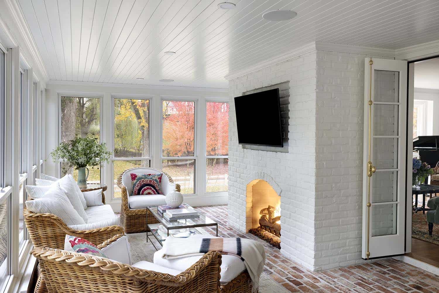 traditional screened porch with a fireplace