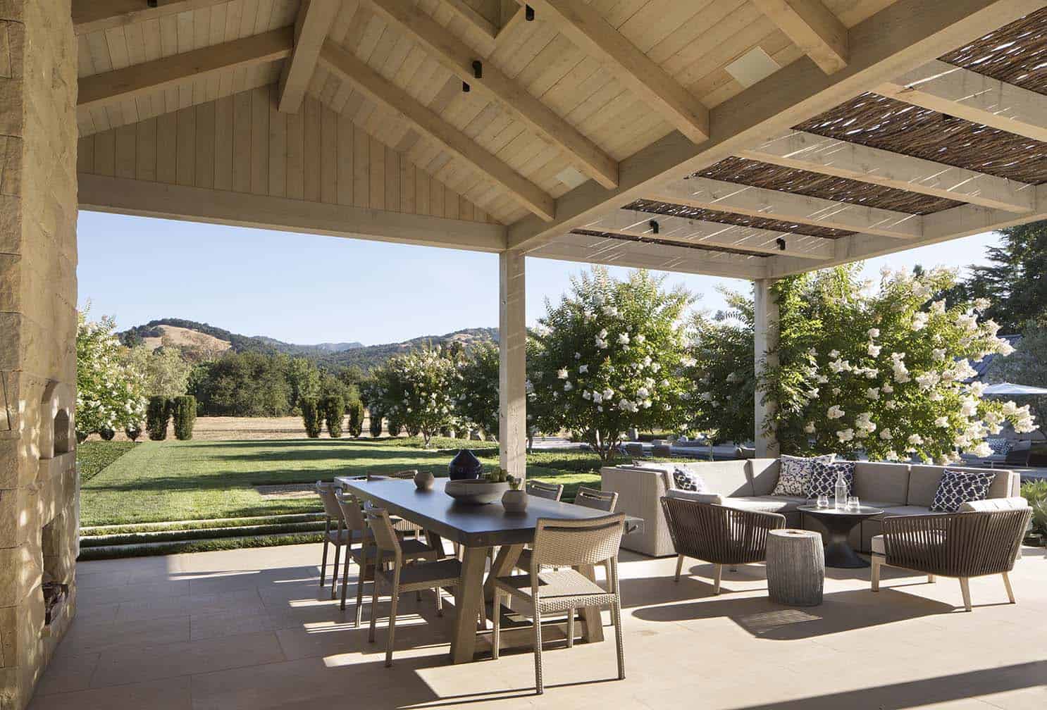 contemporary farmhouse covered patio with outdoor dining and living area