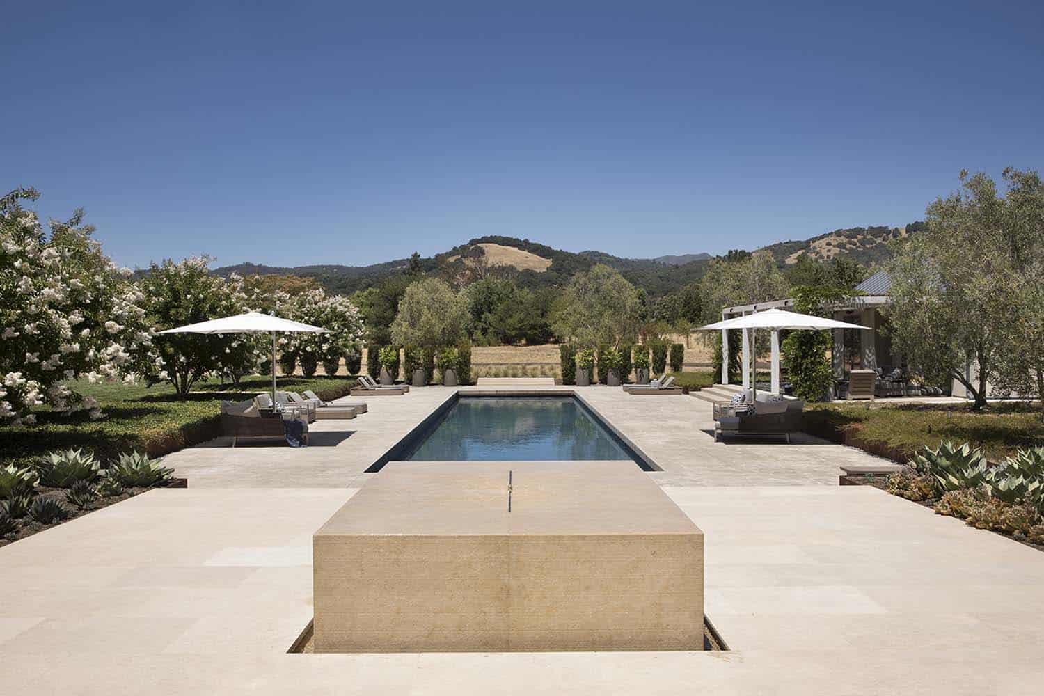 contemporary farmhouse patio with a pool and water feature