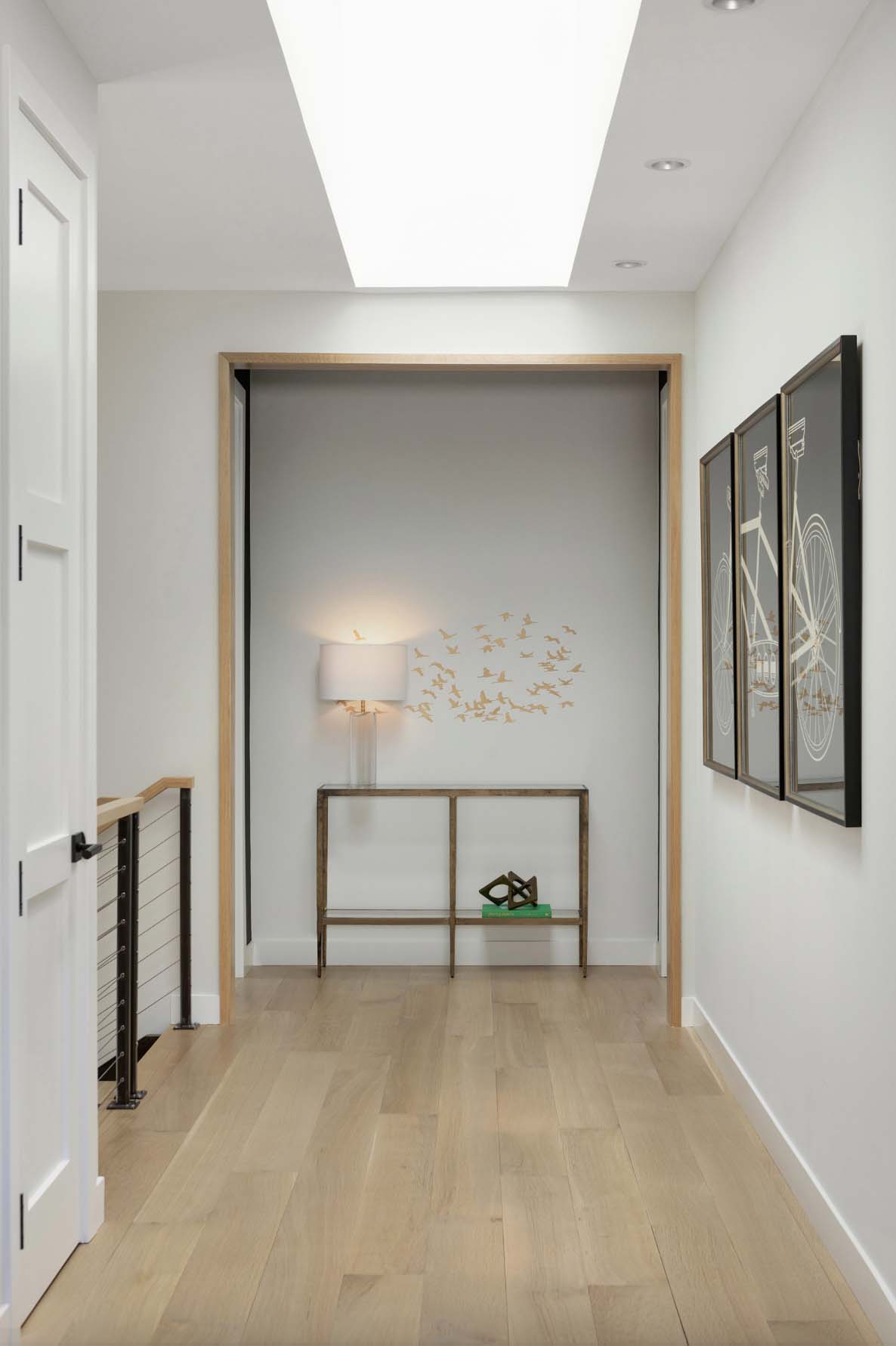 contemporary upstairs hallway with a skylight